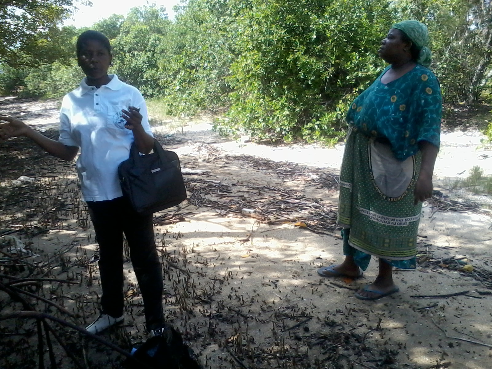 Charperson of DSMC and the local mangoves leader during identification of the area for mangroves replanting.jpg